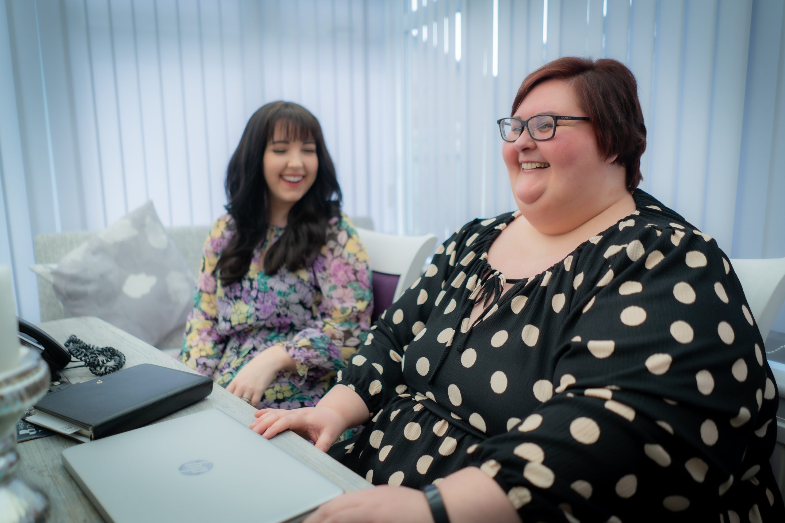 Lady at a computer interviewing someone